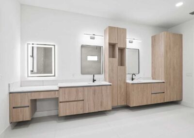 Spacious master bathroom with custom cabinetry and dual vanities in a Vero Beach home