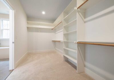 Custom walk-in closet remodel with built-in shelves and hanging space
