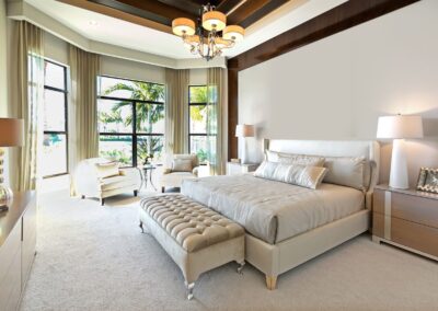 Spacious bedroom addition with large windows, seating area, and palm tree views in Vero Beach.