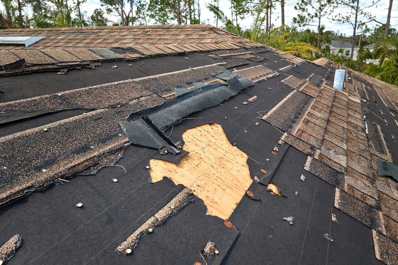 Severe storm damage to shingles exposing underlayment on Fort Pierce Florida home