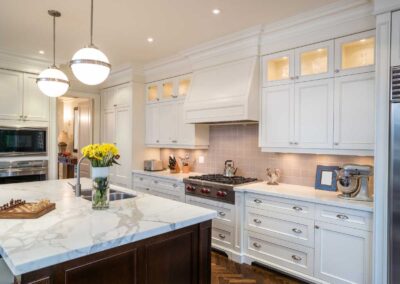 Custom white kitchen remodel with marble island and pendant lighting in Vero Beach